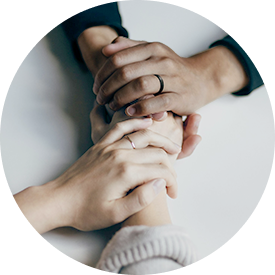 Holding hands across a table with care and concern